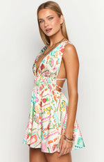 Side view of the white Dolce Vita print mini dress with a deep V-neckline and side waist cutouts