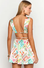 Rear view of the white Dolce Vita print mini dress with a deep open back and thin straps across the waist