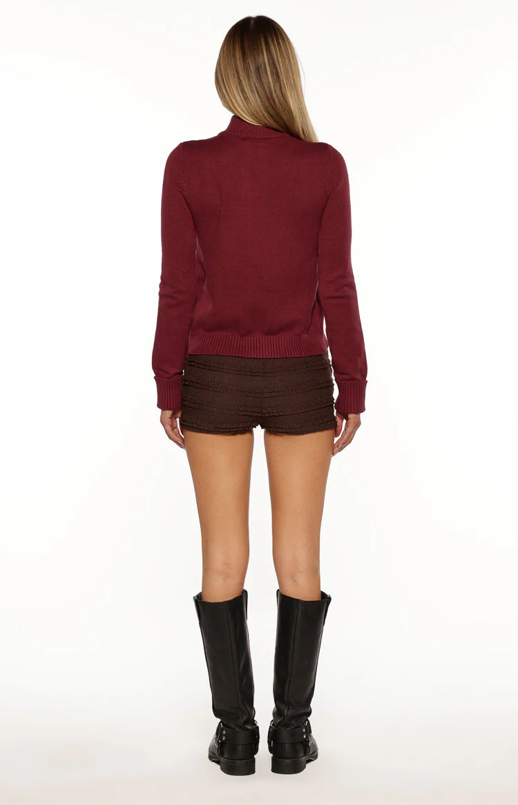 Burgundy zip up knit sweater with a full silver zipper and ribbed cuffs