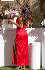 Side view of a red satin maxi dress with a high leg slit and ruched back detail