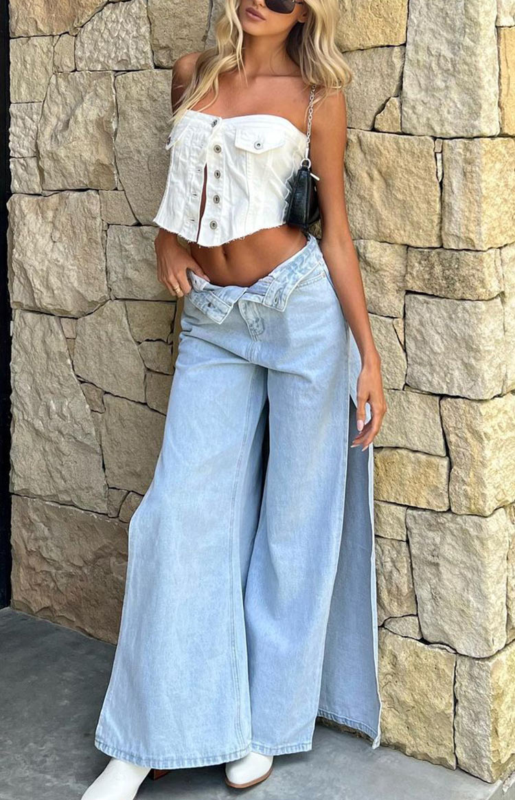 Full length light denim wide leg jeans with high side splits and an unbuttoned, folded waistband