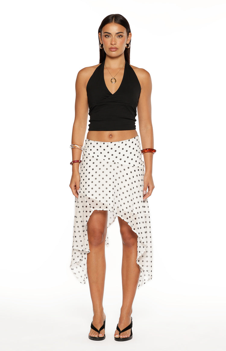 White polka dot midi skirt with a hanky hem and sheer, flowy fabric