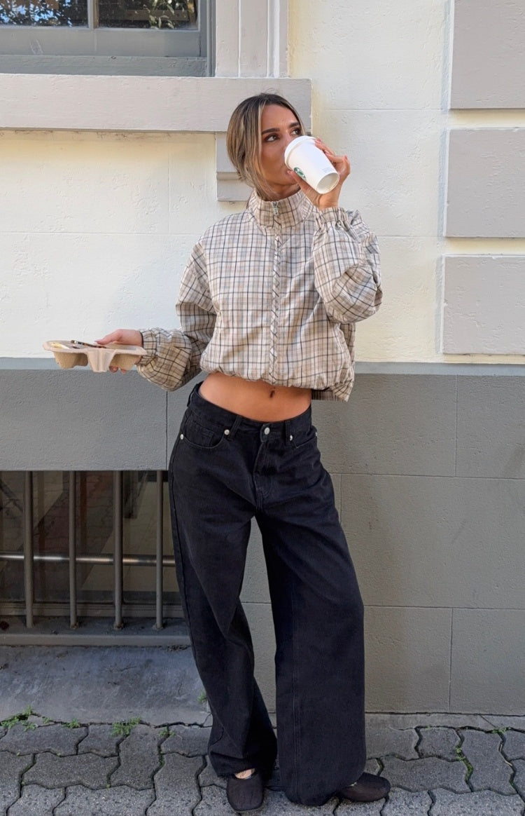 Front view of a beige plaid funnel neck jacket with a full zip, cropped elasticated hem, and long puff sleeves