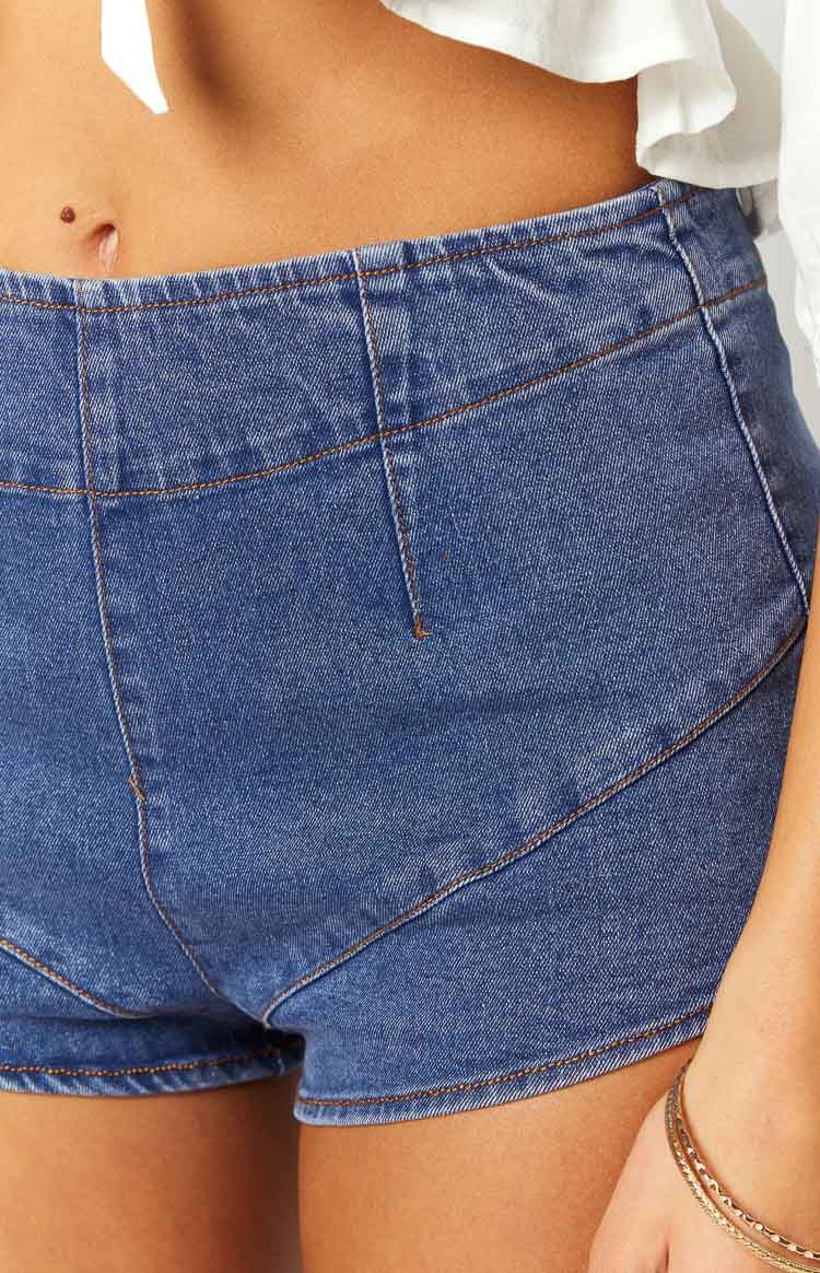 Side view of dark denim micro shorts, highlighting the high-waisted fit and ultra-short cut