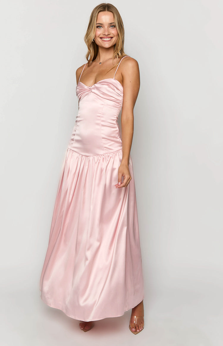 Side view of a pink satin maxi dress with a knotted sweetheart neckline and ruched bodice, flowing into a gathered skirt