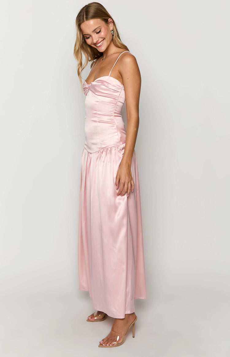 Front view of a pink satin maxi dress with a ruched bust, thin spaghetti straps, and a flowing skirt