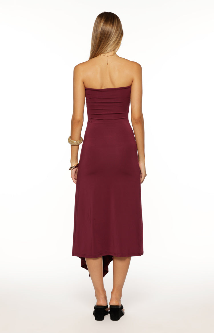 Rear view of a plum strapless midi dress showing the straight back and asymmetrical hemline
