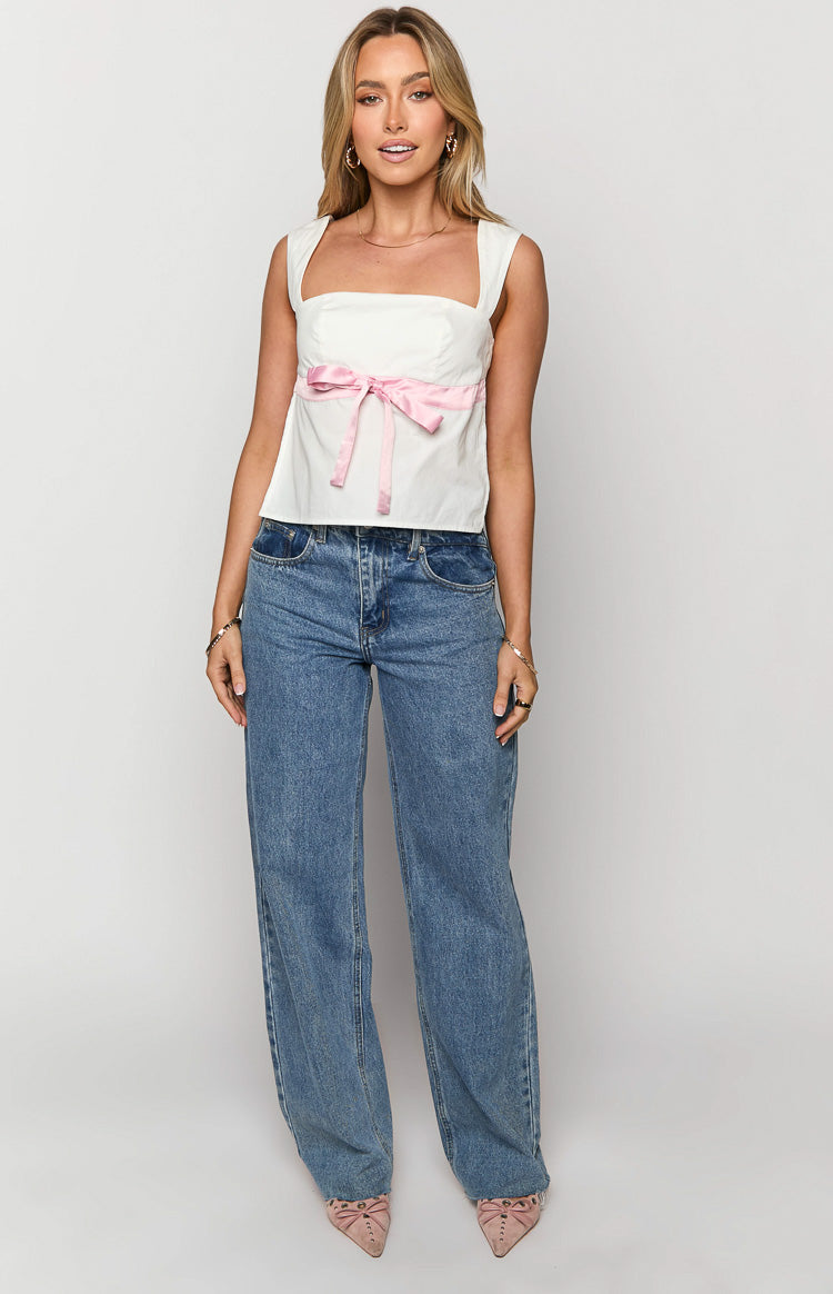Front view of a white square neck top with a pink ribbon bow tied at the front