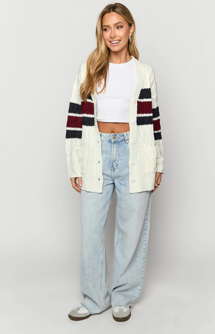 Cream cable knit cardigan with burgundy and navy striped long sleeves and front pockets