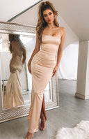 Back view of a champagne satin dress featuring delicate criss-cross straps and a lace-up waist closure