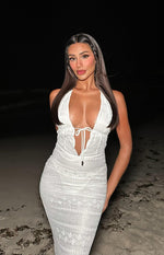 Close-up of the white lace halter maxi dress with deep V-neckline and tie-front bust detail