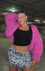 Pink chunky knit cardigan with voluminous long sleeves and an open front