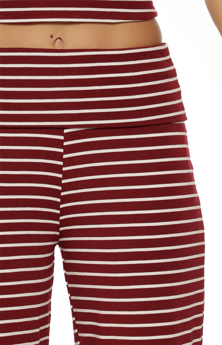 Close-up of the foldover waistband and burgundy and white horizontal stripes on knit wide leg pants