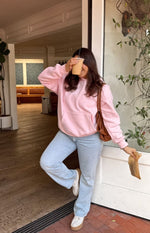 Pink oversized hoodie with a large kangaroo pocket and gathered hem and cuffs