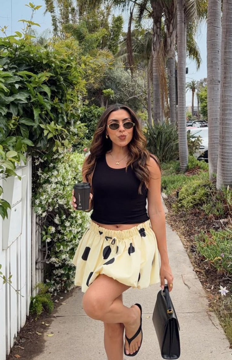 Yellow polka dot bubble hem mini skirt with a full, voluminous silhouette and gathered elasticated waist