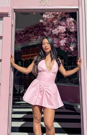 Pink micro mini dress with a deep V-neck and a gathered voluminous skirt