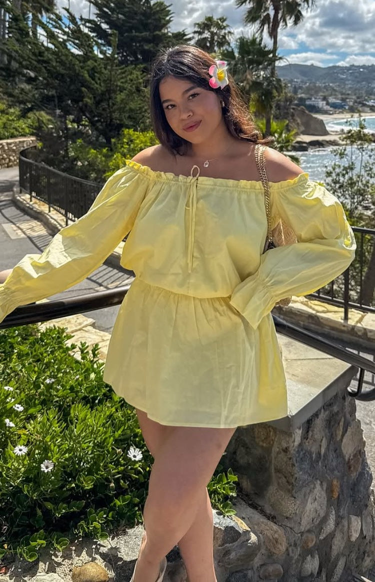 Yellow Bardot mini dress with a ruffled off-shoulder neckline, front tie detail, long billowy sleeves, and elasticated waist