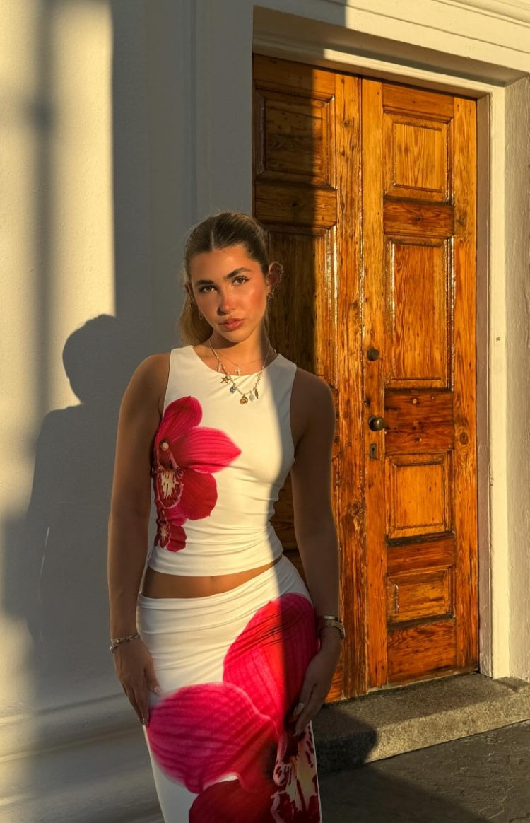 Low-rise white maxi skirt with a large red orchid print on the hip and a fitted silhouette