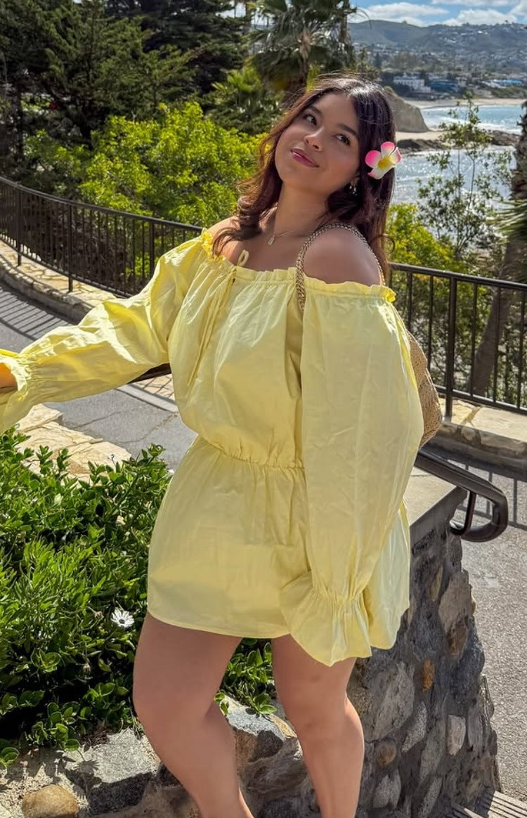 Yellow Bardot mini dress with off-shoulder ruffled neckline, long puff sleeves, elasticated waist, and flowy skirt
