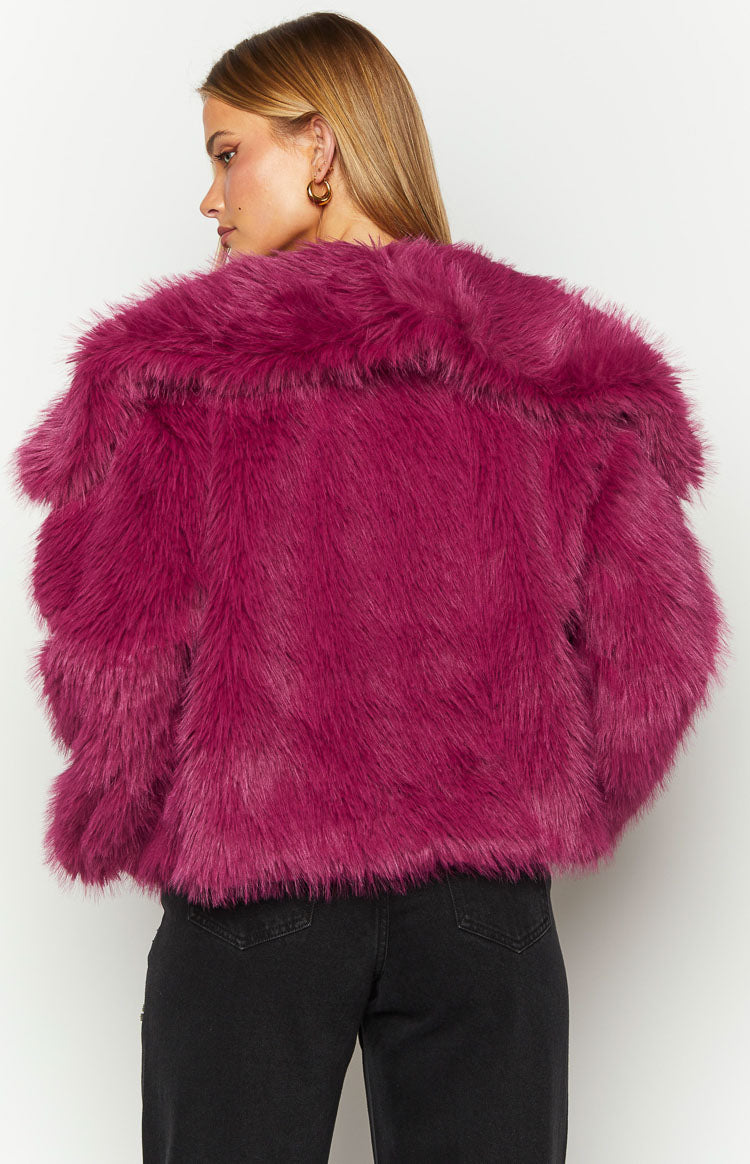Back view of the purple faux fur jacket showing its shaggy texture and wide collar