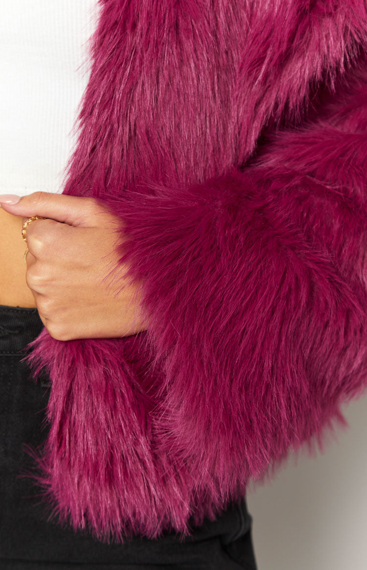 Close-up of the long shaggy purple faux fur texture on the jacket sleeve and body