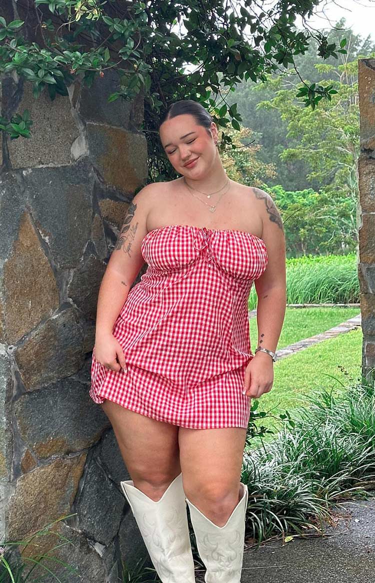 Close-up of the red gingham strapless mini dress showing the ruched bust and tie-front detail