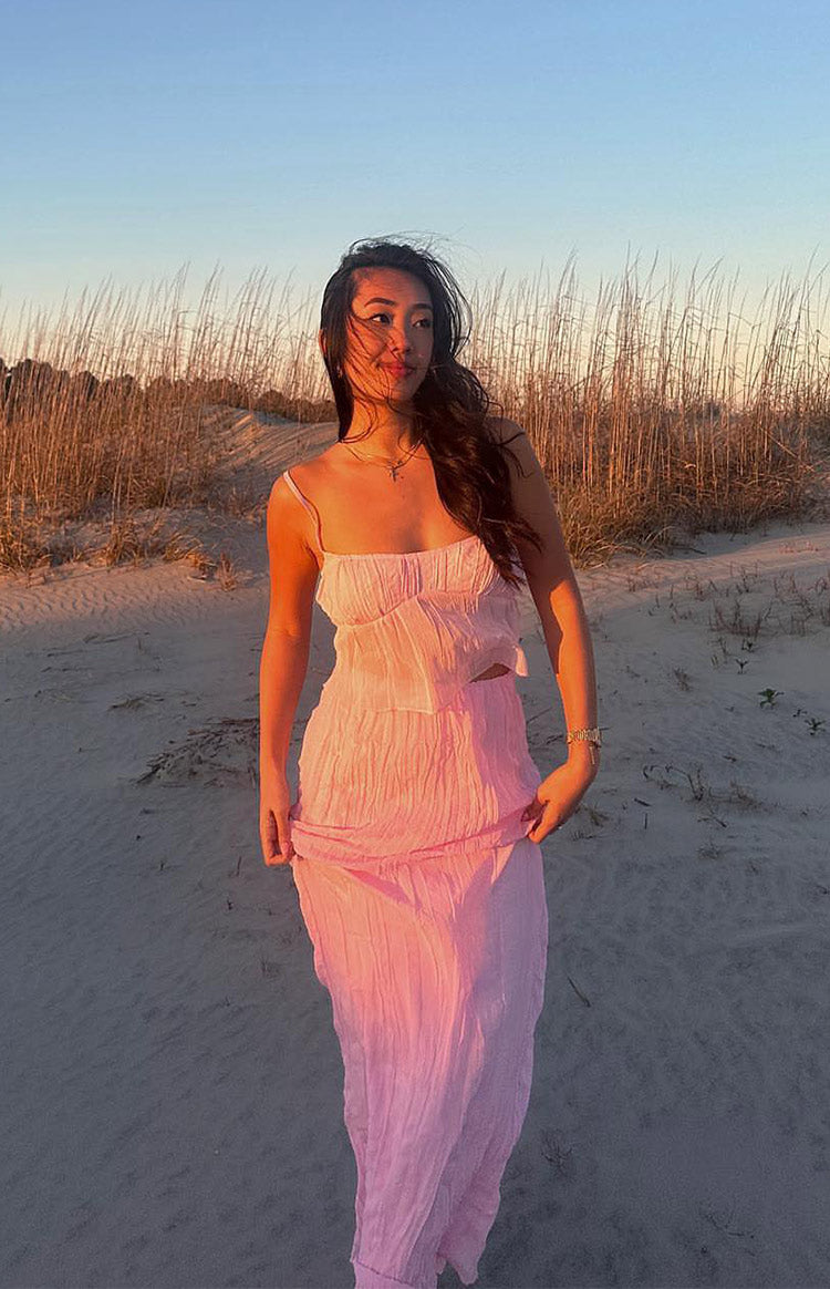 Full length view of a pink crinkled maxi skirt with a relaxed, flowy fit