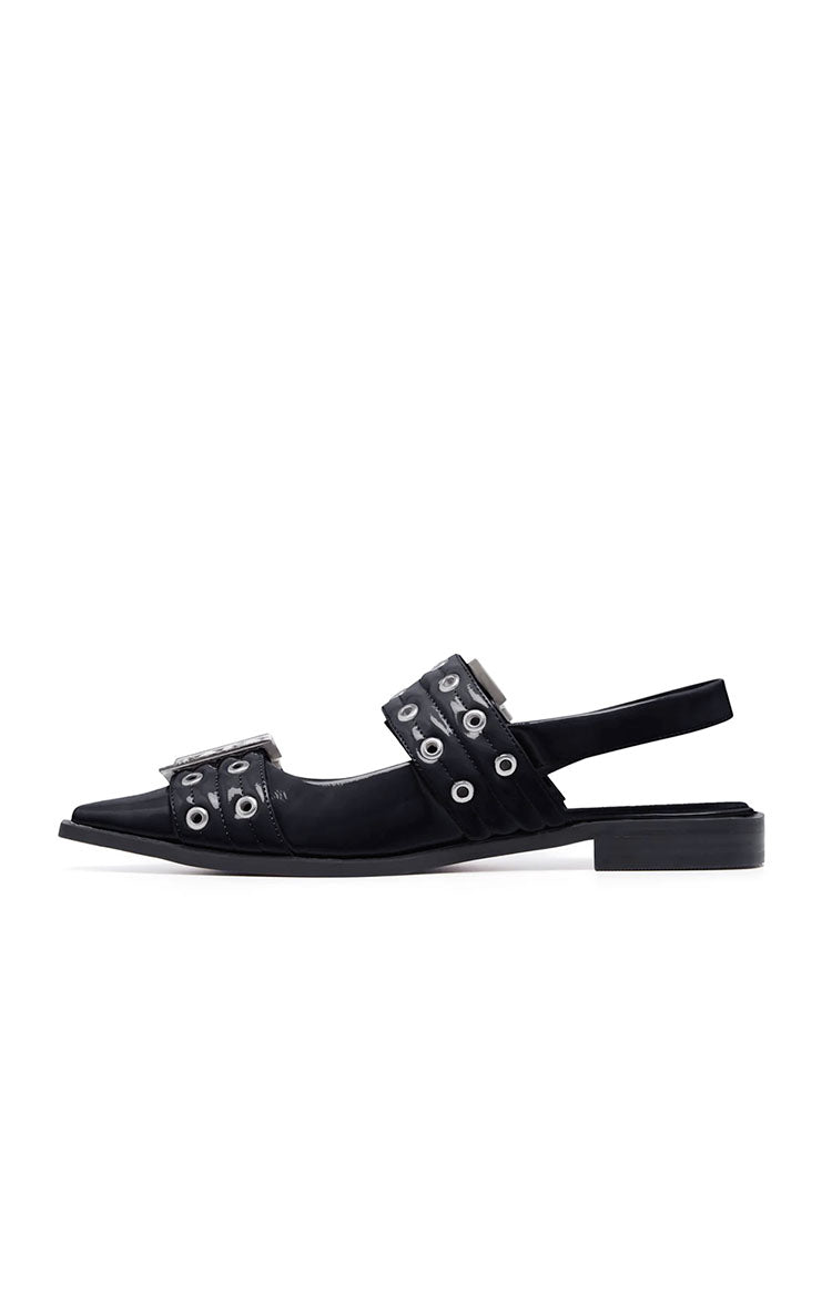Side view of black patent pointed flats with quilted eyelet straps, buckle, and slingback