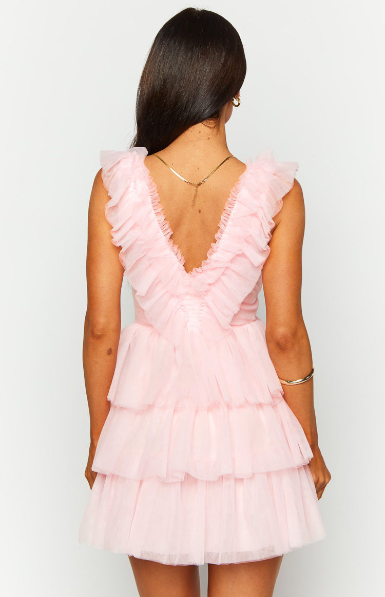 Rear view of a pink tulle mini dress with a deep V-back, ruffled cap sleeves, ruched bodice, and tiered skirt