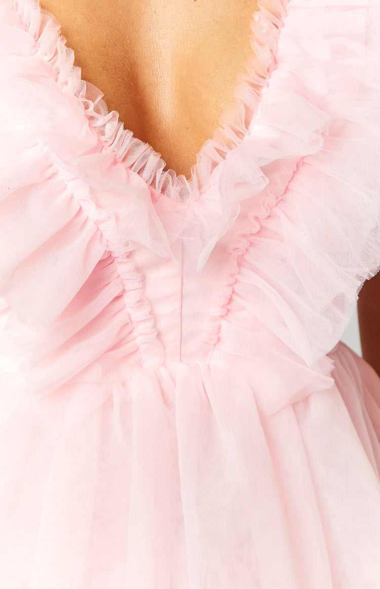 Close-up showing the pink tulle V-neckline with ruffled trim and ruched bodice