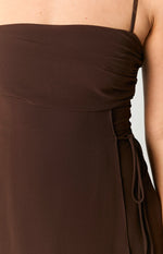 Close-up of the brown mini dress showing ruched side bodice and adjustable drawstring ties on the skirt