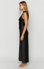 Side view of a black satin maxi dress with a cowl neck and flowing skirt