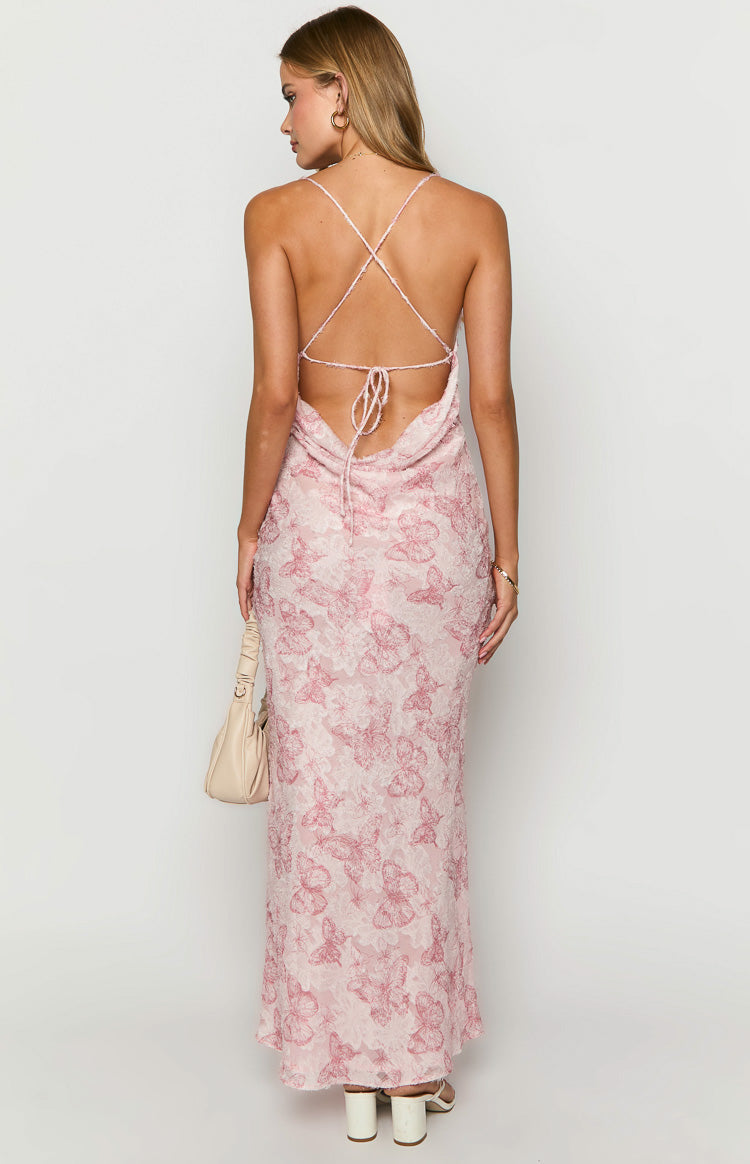 High-angle view of a pink maxi dress with a textured butterfly pattern and cowl neckline