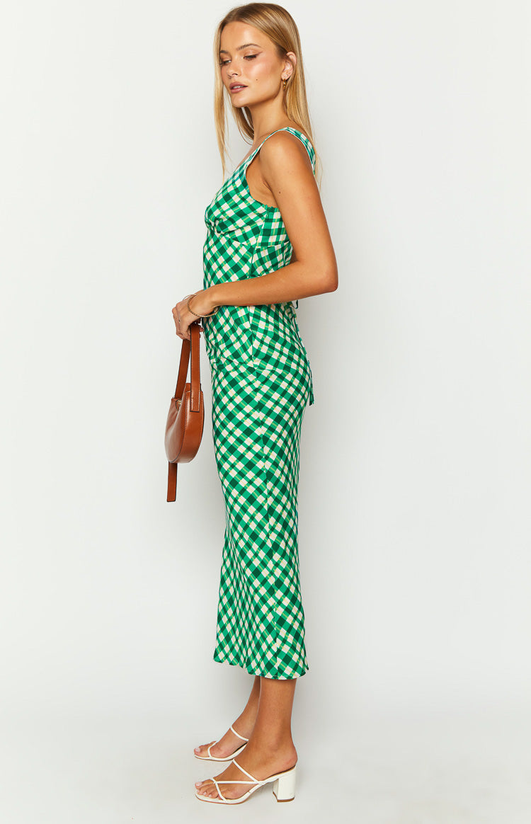 Side view of a green and white check maxi dress with a square neckline and a slim silhouette