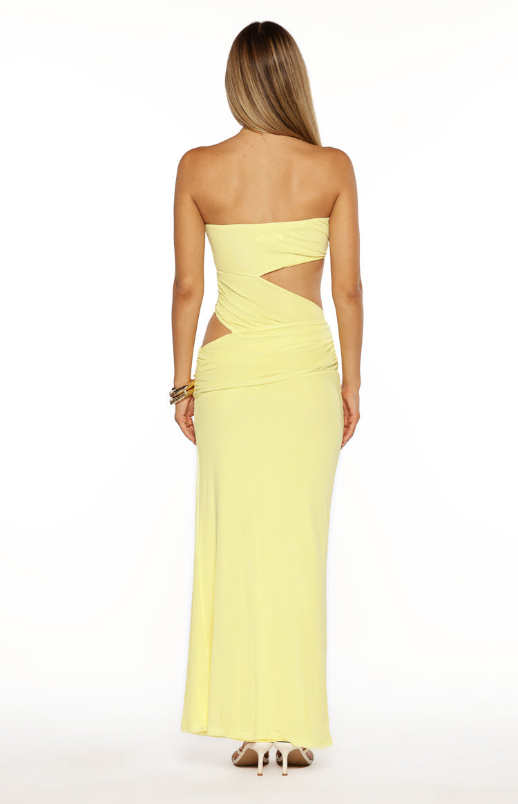 Rear view of a yellow strapless maxi dress with side cutouts and ruched detailing
